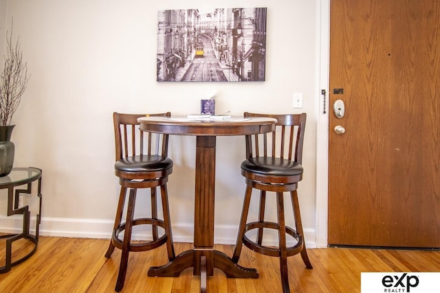 interior space featuring wood finished floors and baseboards