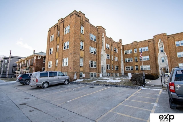 view of building exterior with uncovered parking