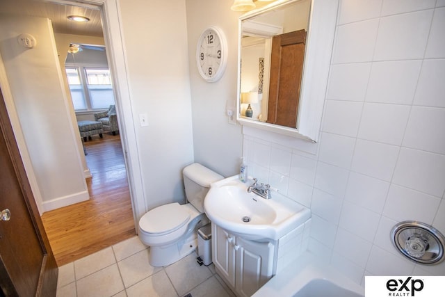 bathroom featuring tile patterned floors, toilet, and a sink