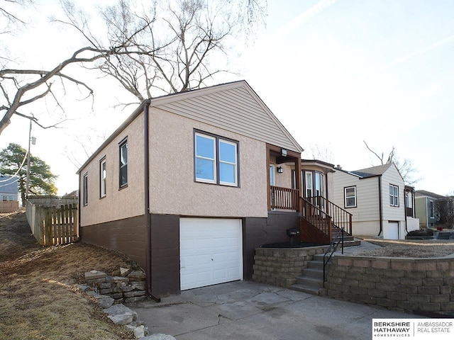 view of front of property with stucco siding, concrete driveway, and an attached garage