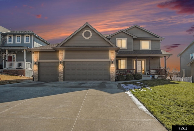 view of front of home featuring a front lawn, stone siding, a porch, concrete driveway, and a garage