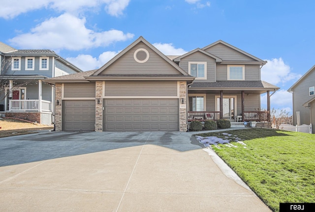 craftsman house with concrete driveway, a front yard, covered porch, a garage, and stone siding