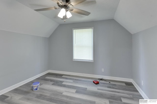 bonus room with ceiling fan, baseboards, wood finished floors, and vaulted ceiling