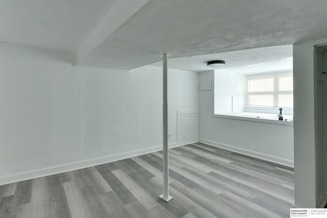 basement with wood finished floors and baseboards