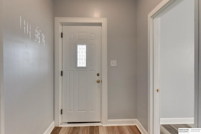 foyer with wood finished floors and baseboards