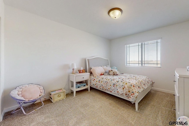 bedroom with baseboards and light carpet