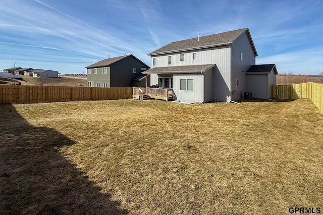 back of house featuring a yard, cooling unit, a wooden deck, and a fenced backyard