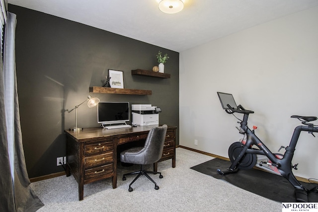 carpeted office space featuring baseboards