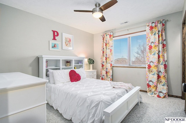 bedroom with visible vents, light carpet, baseboards, and a ceiling fan