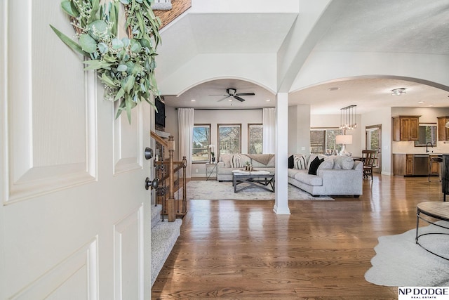 foyer entrance with wood finished floors, recessed lighting, arched walkways, baseboards, and ceiling fan