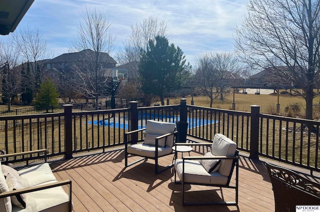 deck with a swimming pool and fence