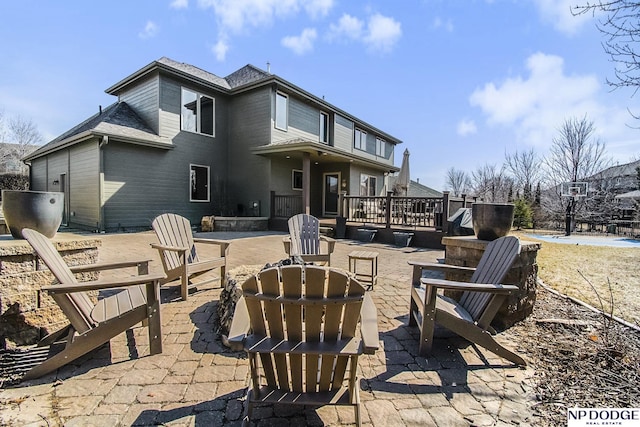 view of patio with a wooden deck and an outdoor fire pit