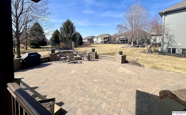 view of patio featuring a trampoline and a grill