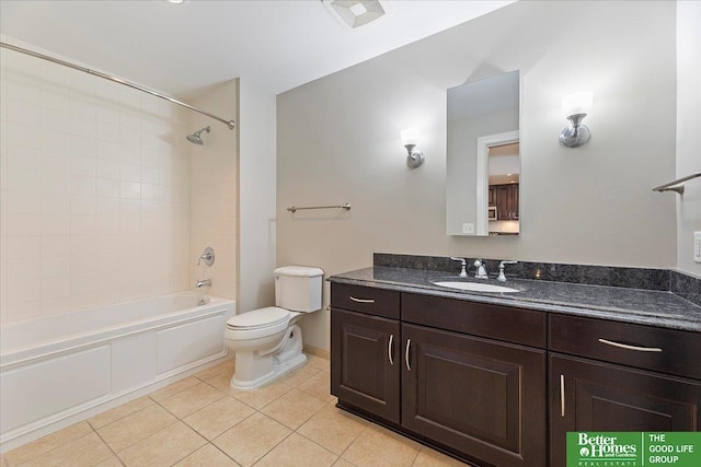 bathroom with tile patterned floors, toilet,  shower combination, and vanity