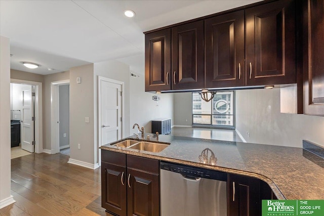 kitchen with baseboards, dark brown cabinetry, dishwasher, wood finished floors, and a sink