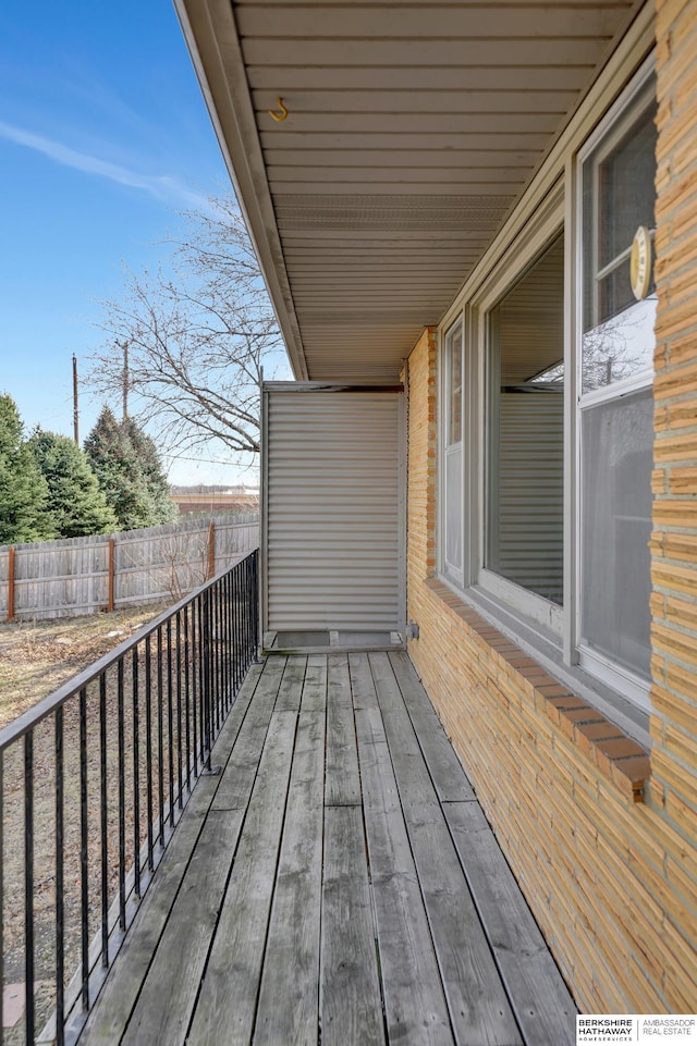 wooden terrace featuring fence