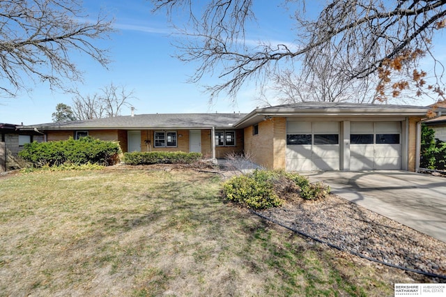 ranch-style house with a front lawn, brick siding, concrete driveway, and an attached garage