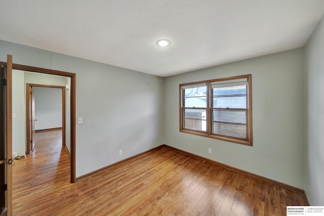 unfurnished room featuring visible vents, baseboards, and light wood finished floors