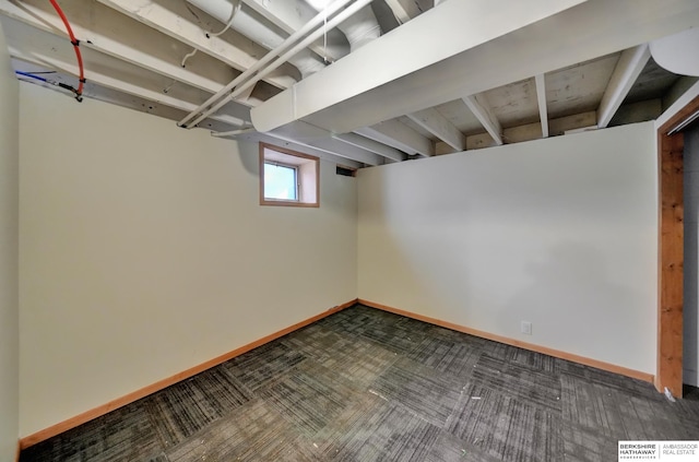 below grade area with baseboards and carpet floors