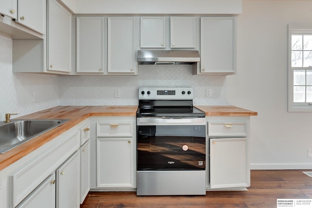 kitchen with decorative backsplash, wooden counters, extractor fan, and stainless steel range with electric cooktop