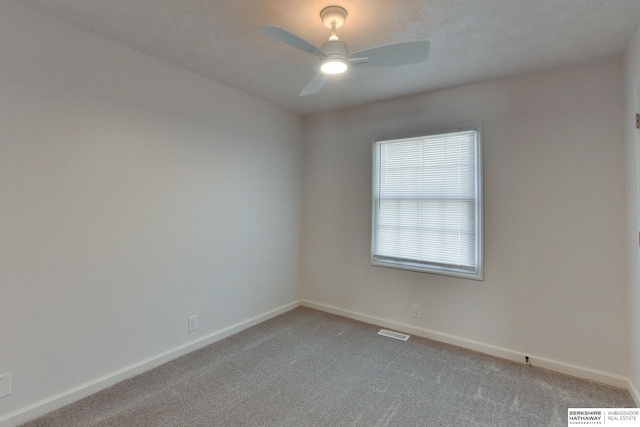 unfurnished room with visible vents, ceiling fan, baseboards, and carpet floors