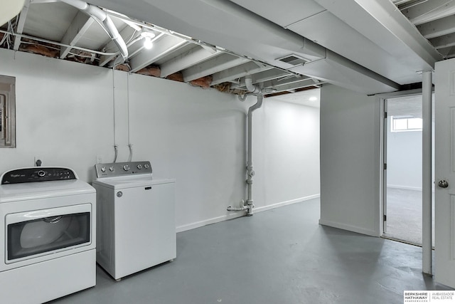 laundry room featuring laundry area, separate washer and dryer, visible vents, and baseboards