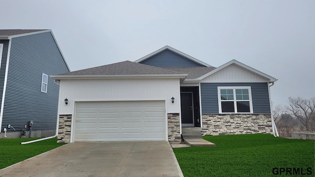 view of front facade featuring driveway, entry steps, roof with shingles, a front yard, and a garage