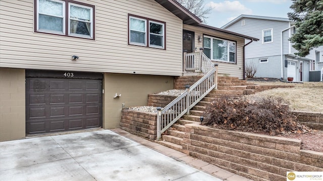 view of front of property with concrete driveway and a garage