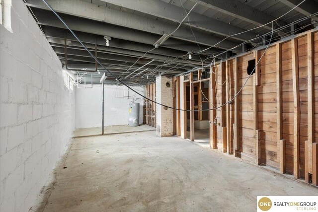 unfinished below grade area featuring gas water heater