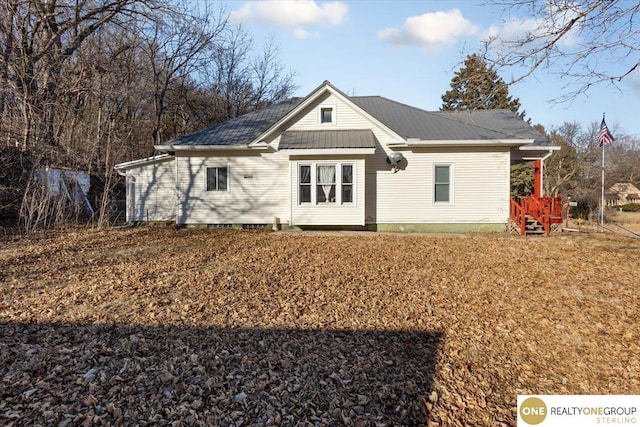back of house with metal roof
