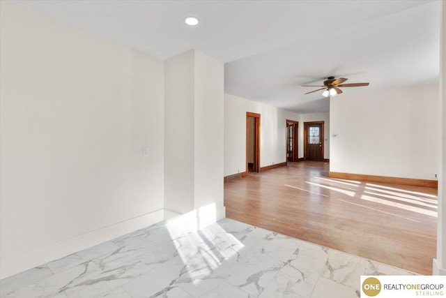 spare room with recessed lighting, baseboards, marble finish floor, and a ceiling fan