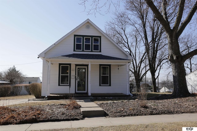 bungalow-style home featuring covered porch and a shingled roof