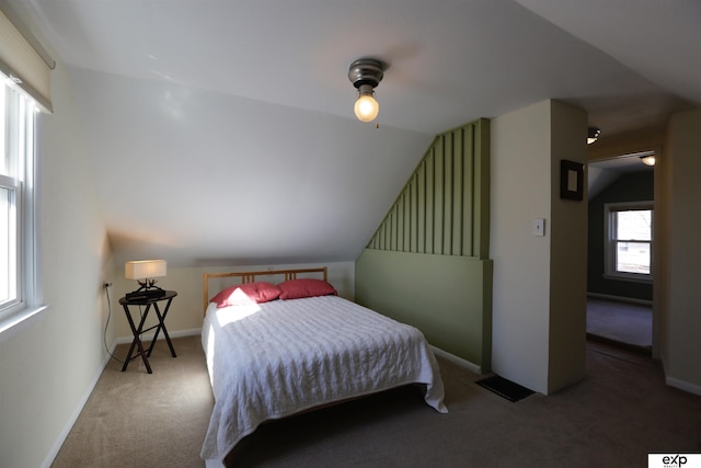 bedroom featuring vaulted ceiling, baseboards, and carpet floors