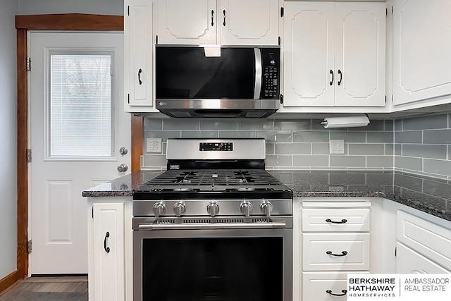 kitchen featuring white cabinetry, dark stone countertops, tasteful backsplash, and appliances with stainless steel finishes