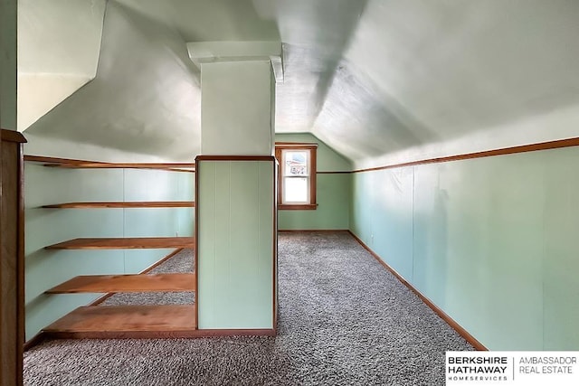 bonus room featuring baseboards, carpet, and vaulted ceiling