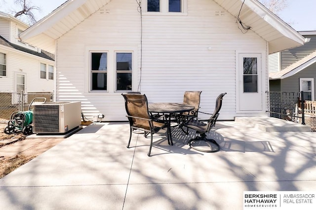 view of patio / terrace featuring outdoor dining space, central AC unit, and fence