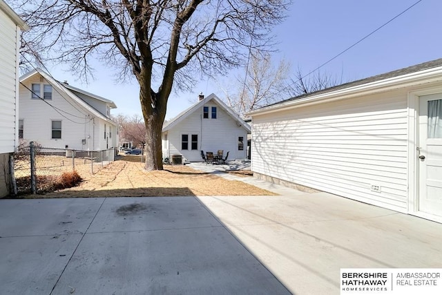 rear view of house featuring a patio and fence