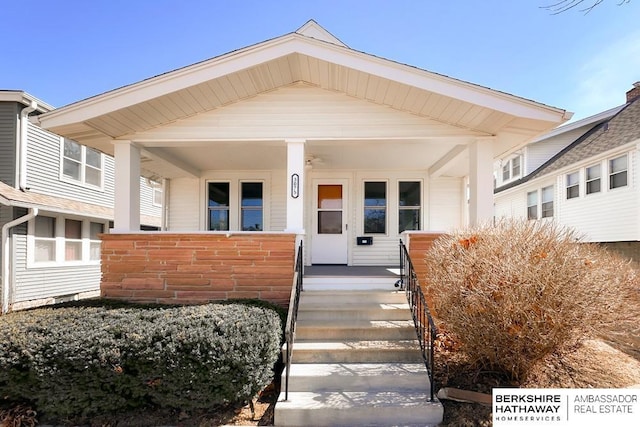 view of exterior entry featuring covered porch