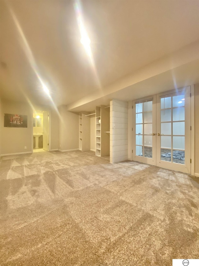 interior space featuring carpet flooring, french doors, and baseboards