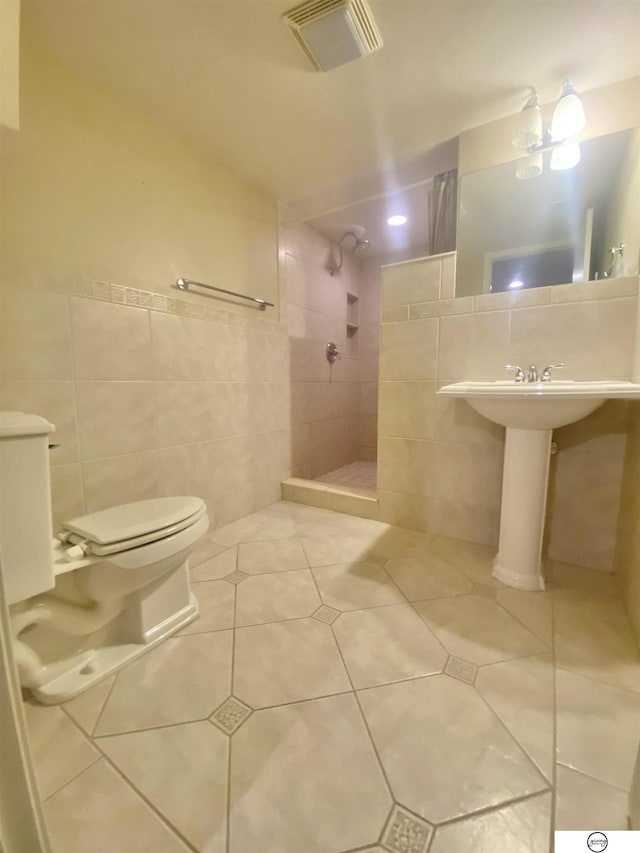 full bath featuring visible vents, a walk in shower, tile walls, toilet, and tile patterned floors