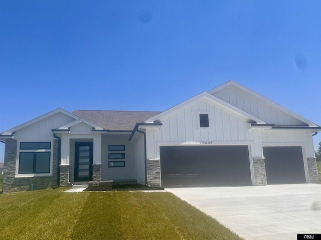 view of front of home with stone siding, an attached garage, and board and batten siding