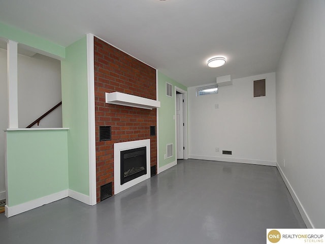 unfurnished living room featuring visible vents, baseboards, and finished concrete flooring