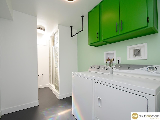 washroom featuring baseboards, cabinet space, and washing machine and dryer