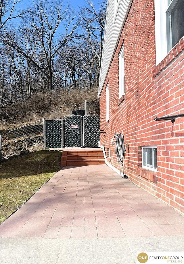 view of patio featuring a gate and fence