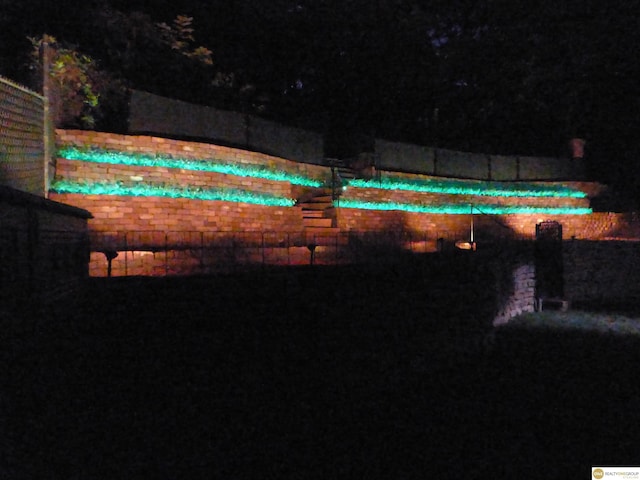 view of pool at twilight