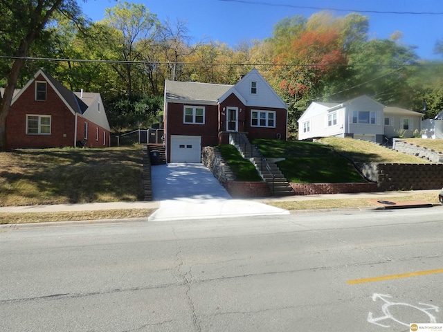 view of front of property with driveway, a front yard, and an attached garage