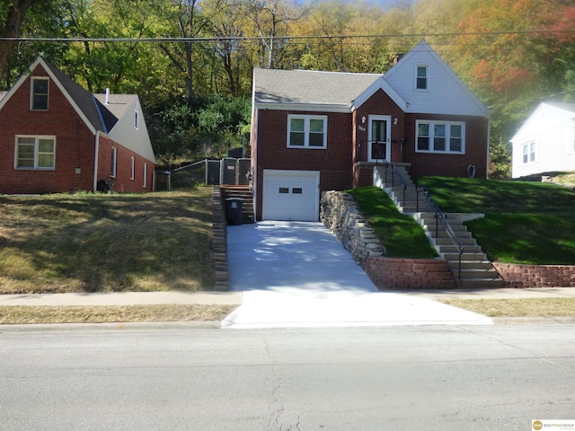 view of front facade with brick siding, a front lawn, concrete driveway, and a garage