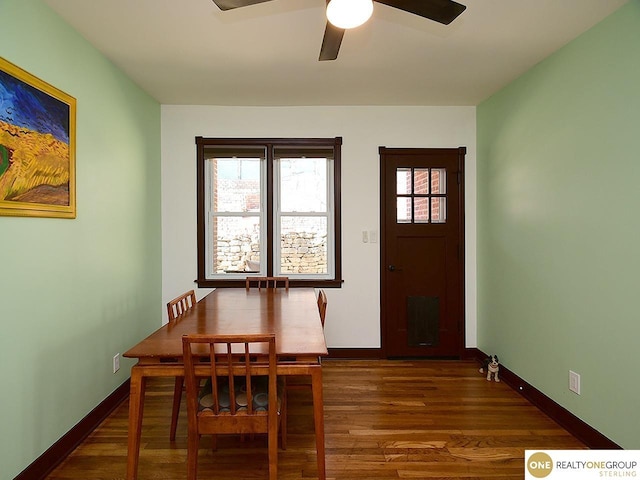 dining room featuring wood finished floors, baseboards, and ceiling fan