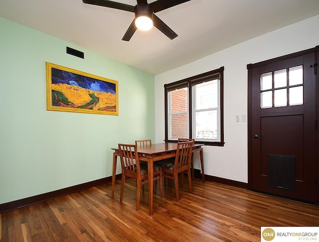 dining area with baseboards, ceiling fan, and dark wood-style flooring