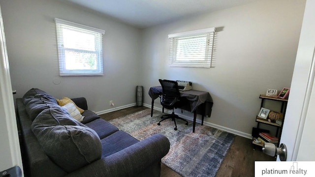 home office with plenty of natural light, baseboards, and dark wood-style flooring